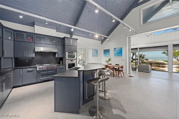 a kitchen with lots of counter top space and furniture