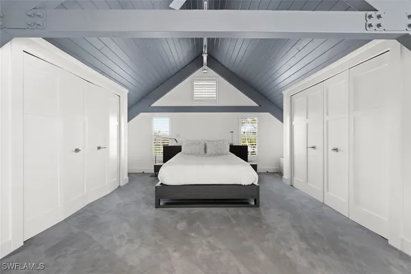 a bed room with a bed and a window