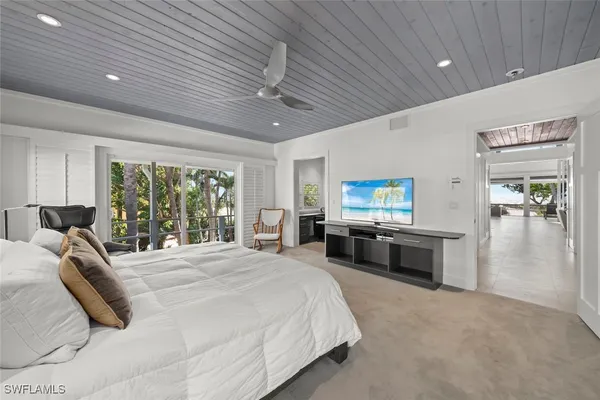 a large bedroom with a bed and a chandelier