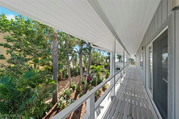 a view of a balcony with wooden floor