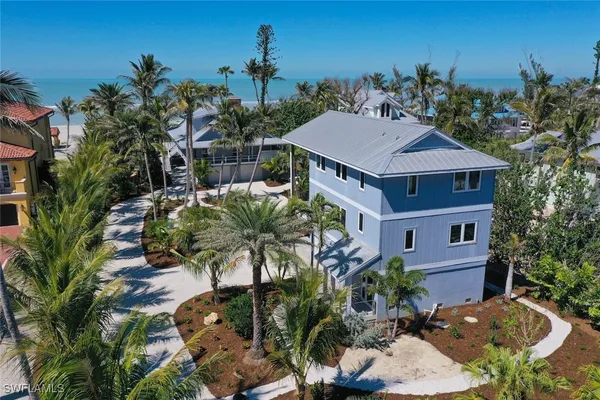 a aerial view of a house with a yard and potted plants