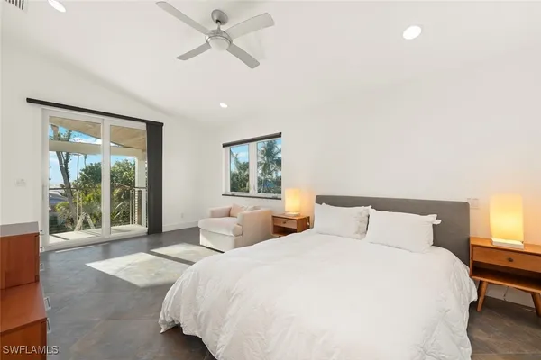 a bedroom with a large bed and a large window