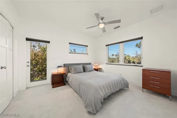 a bedroom with a bed and cabinet