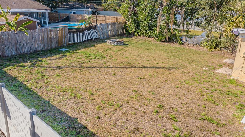 9696 Groveland Street Seminole, FL 33772 - Photo 14 of 22 a view of a backyard with wooden fence
