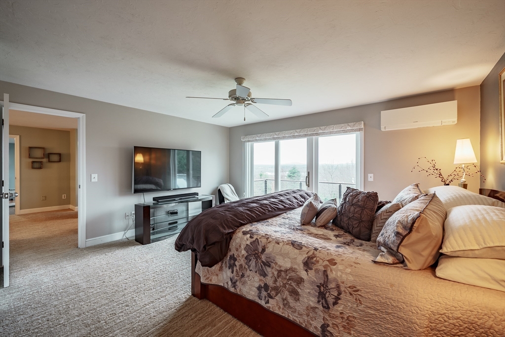 110 Kettle Hole Road Bolton, MA 01740 - Photo 31 of 40 a bedroom with a bed and a flat screen tv
