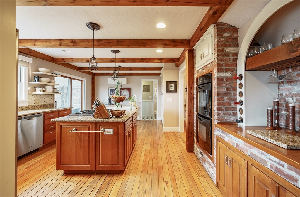 110 Kettle Hole Road Bolton, MA 01740 - Photo 8 of 40 a view of a kitchen with stainless steel appliances granite countertop a stove and wooden floor