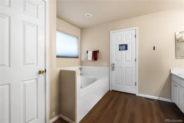 a bathroom with a bathtub and a window