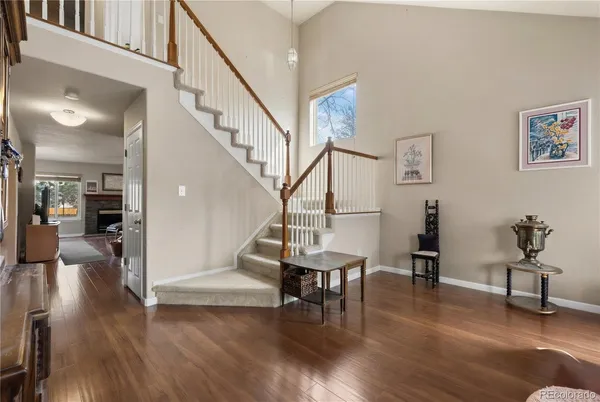 a view of a livingroom with furniture and hardwood floor