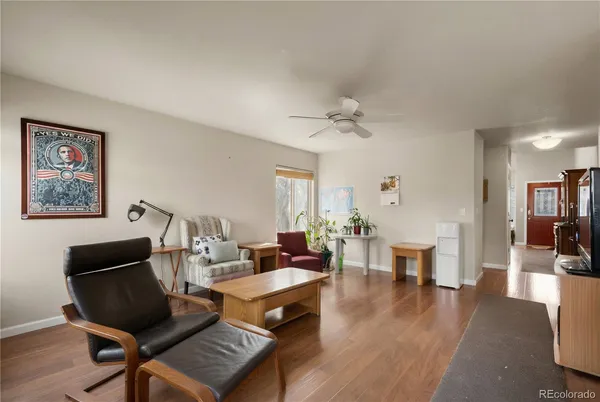 a living room with furniture and wooden floor