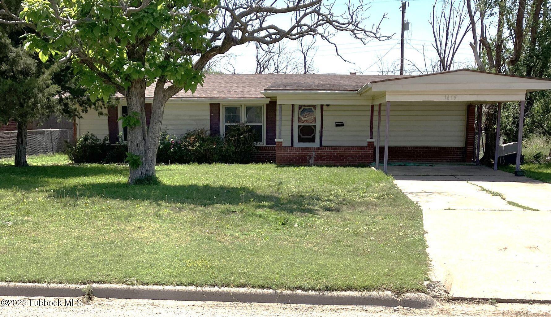 a view of a white house with a big yard and large trees