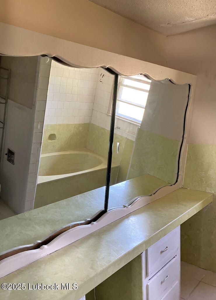 1615 Utica Plainview, TX 79072 - Photo 19 of 26 a bathroom with a sink and a mirror