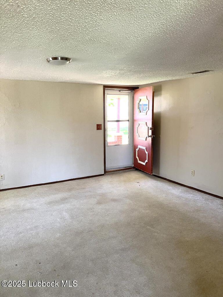 1615 Utica Plainview, TX 79072 - Photo 3 of 26 a view of an empty room with window