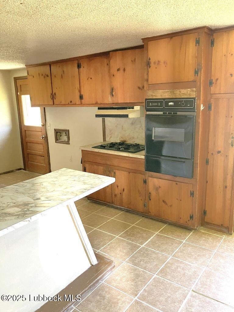 1615 Utica Plainview, TX 79072 - Photo 5 of 26 a kitchen with stainless steel appliances kitchen island granite countertop a sink and cabinets