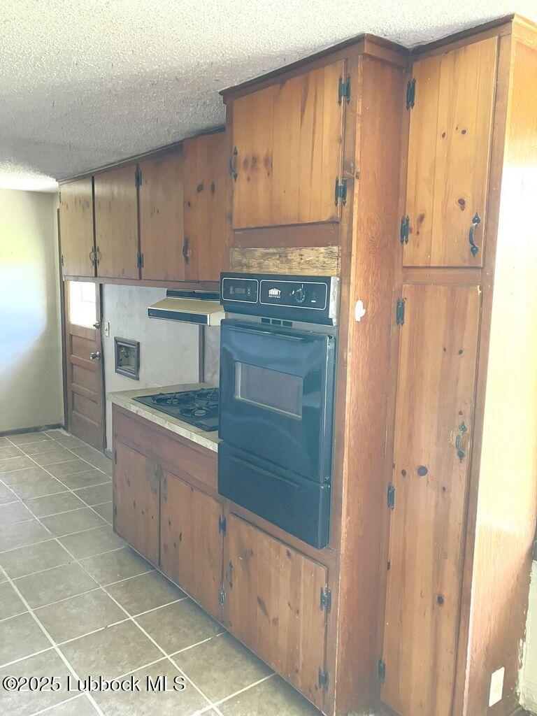 1615 Utica Plainview, TX 79072 - Photo 6 of 26 a kitchen with stainless steel appliances granite countertop a refrigerator and a stove