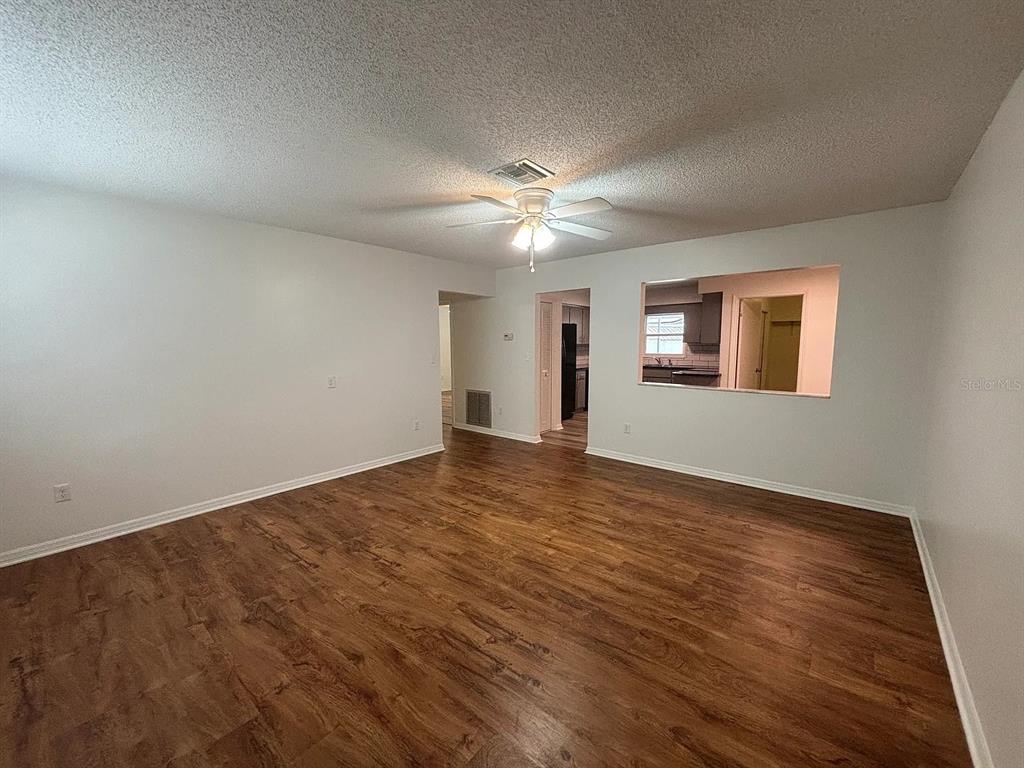 2413 Ave B Southwest, Unit A Winter Haven, FL 33880 - Photo 2 of 11 wooden floor in an empty room with a window