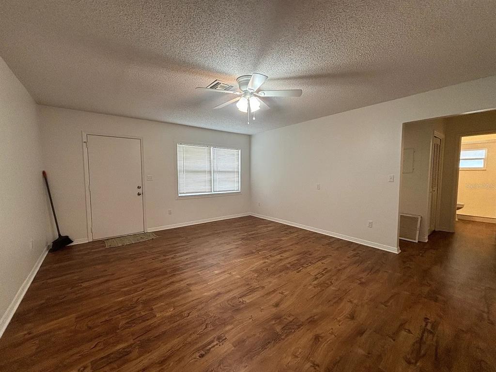2413 Ave B Southwest, Unit A Winter Haven, FL 33880 - Photo 3 of 11 wooden floor in an empty room with a window