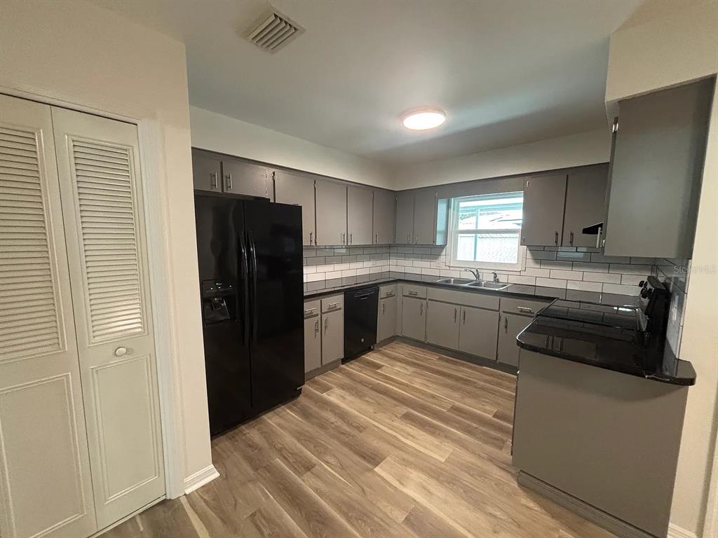 2413 Ave B Southwest, Unit A Winter Haven, FL 33880 - Photo 5 of 11 a kitchen with a refrigerator stove and sink