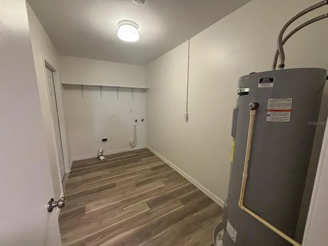 a view of a room with wooden floor