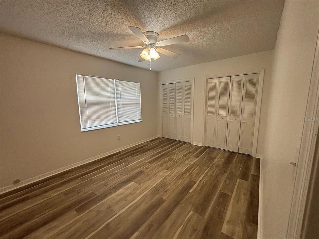2413 Ave B Southwest, Unit A Winter Haven, FL 33880 - Photo 7 of 11 a view of an empty room with wooden floor and a window