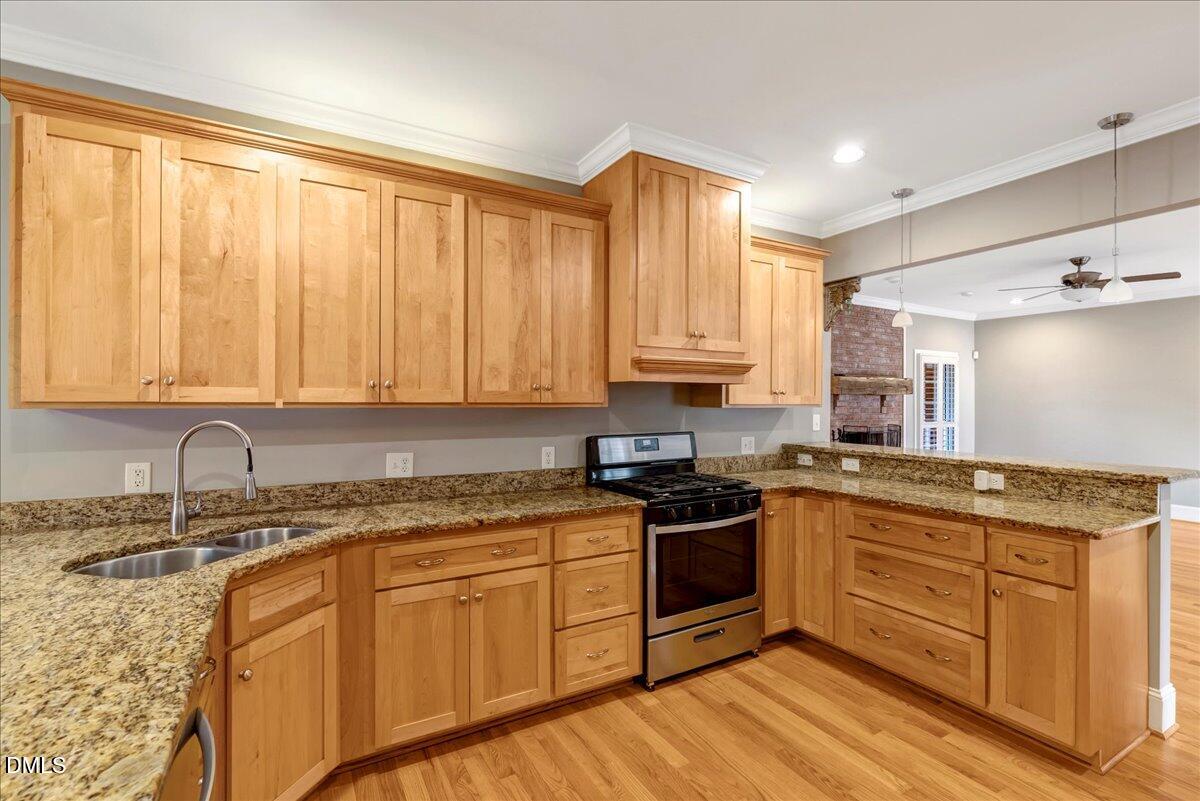 1635 Tommie Daniel Road Oxford, NC 27565 - Photo 15 of 63 a kitchen with stainless steel appliances granite countertop a stove a sink and white cabinets