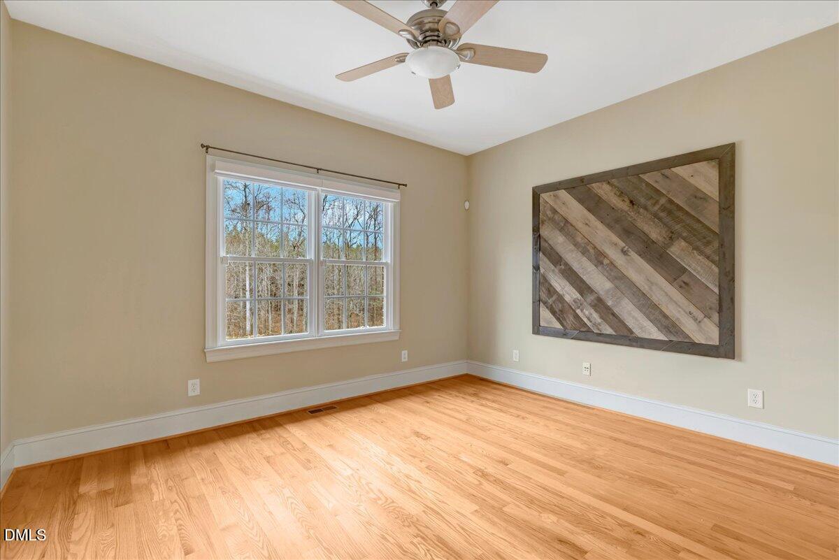 1635 Tommie Daniel Road Oxford, NC 27565 - Photo 23 of 63 a view of an empty room with wooden floor and a window
