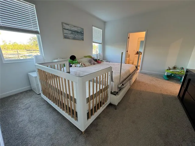 a view of a bedroom with furniture and windows