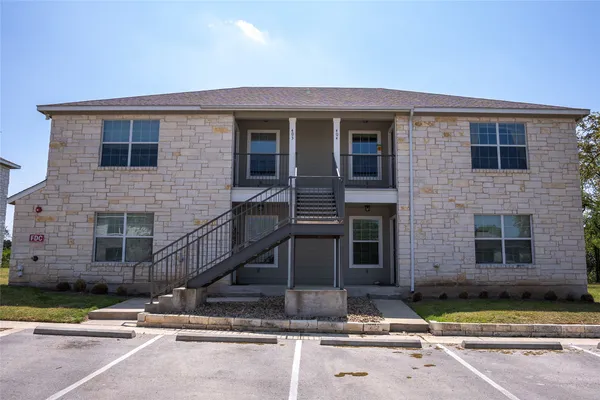 a front view of a house with stairs