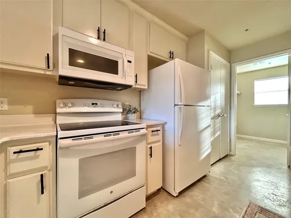 a kitchen with a stove microwave and refrigerator