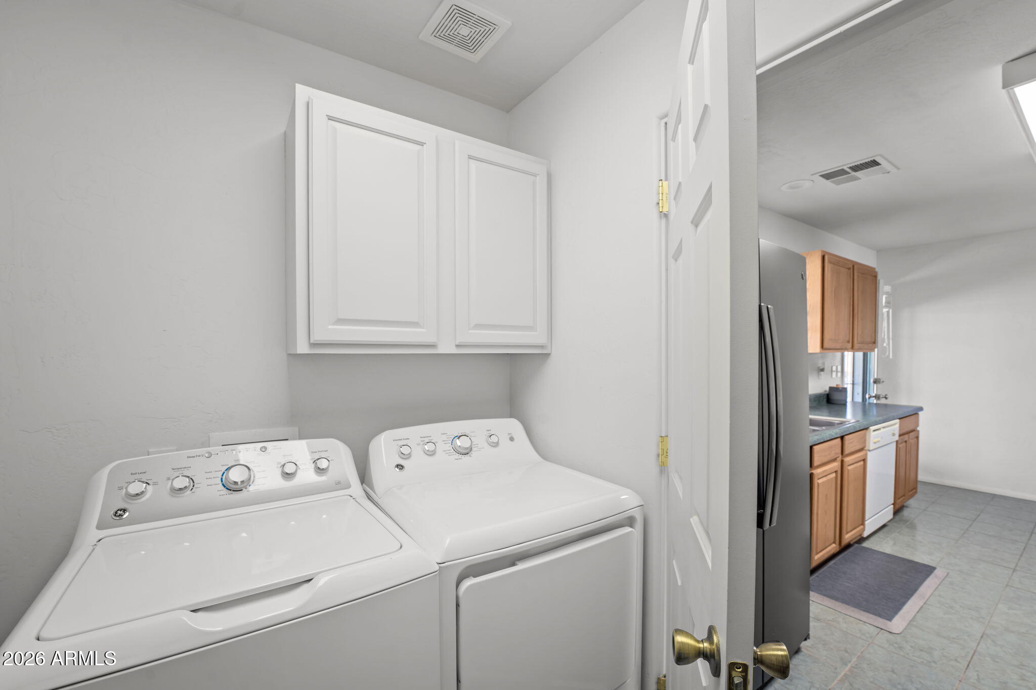 27144 Bennett Way Congress, AZ 85332 - Photo 19 of 33 a view of washer and dryer with bathroom in the background