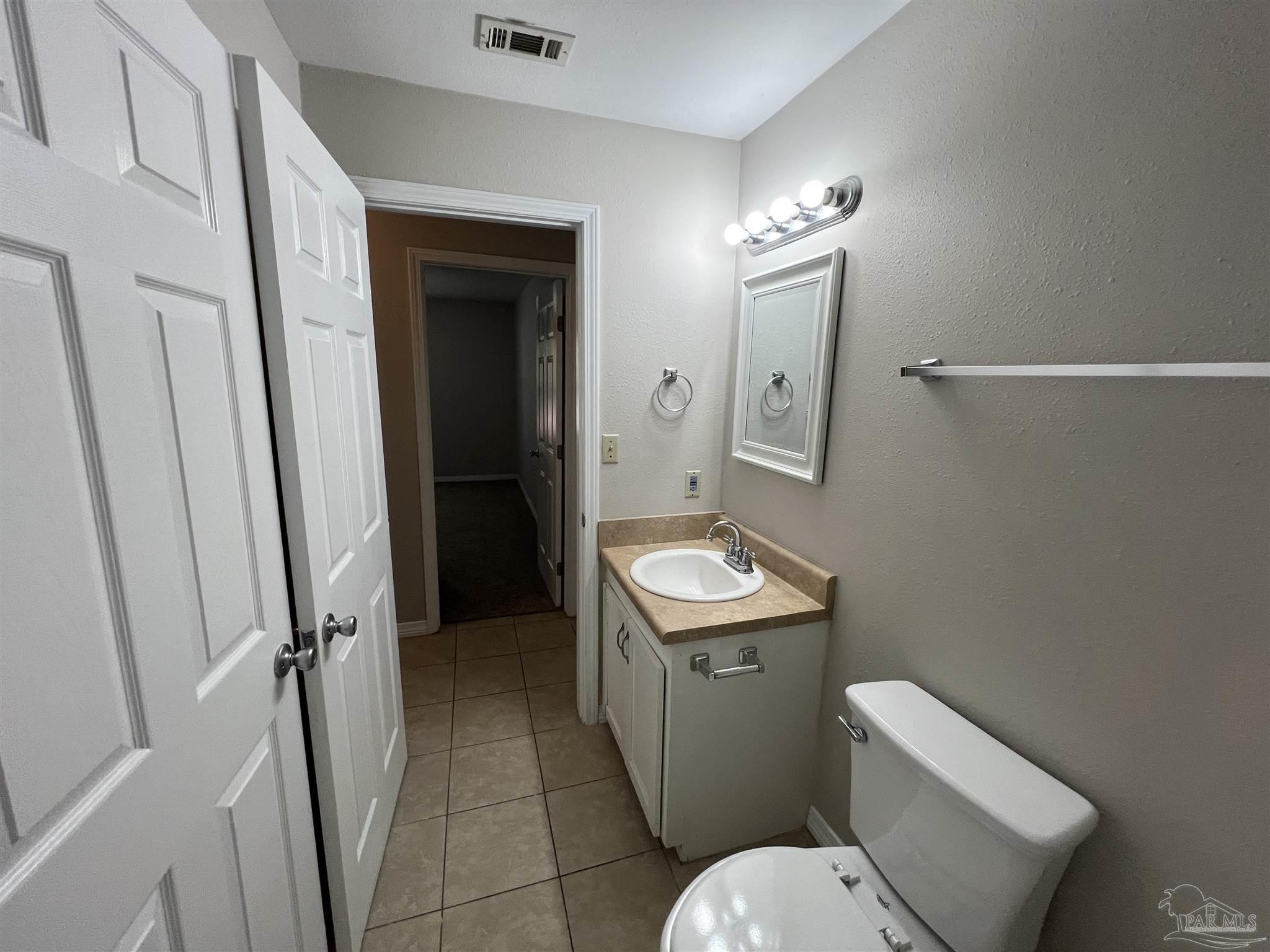 9485 Sunnehanna Boulevard Pensacola, FL 32514 - Photo 11 of 24 a bathroom with a toilet sink and shower
