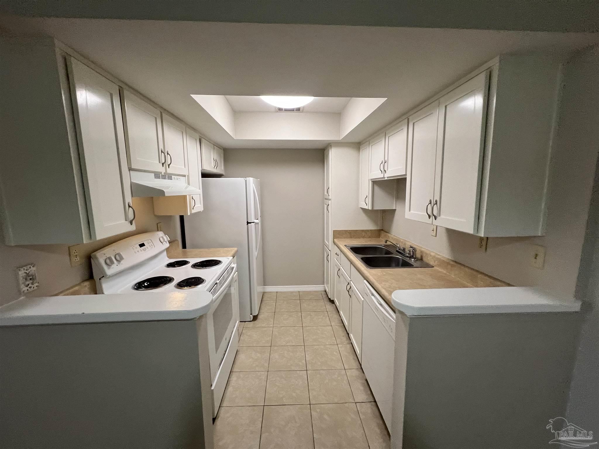 9485 Sunnehanna Boulevard Pensacola, FL 32514 - Photo 3 of 24 a kitchen with stainless steel appliances a stove top oven a sink a refrigerator white cabinets and wooden floor
