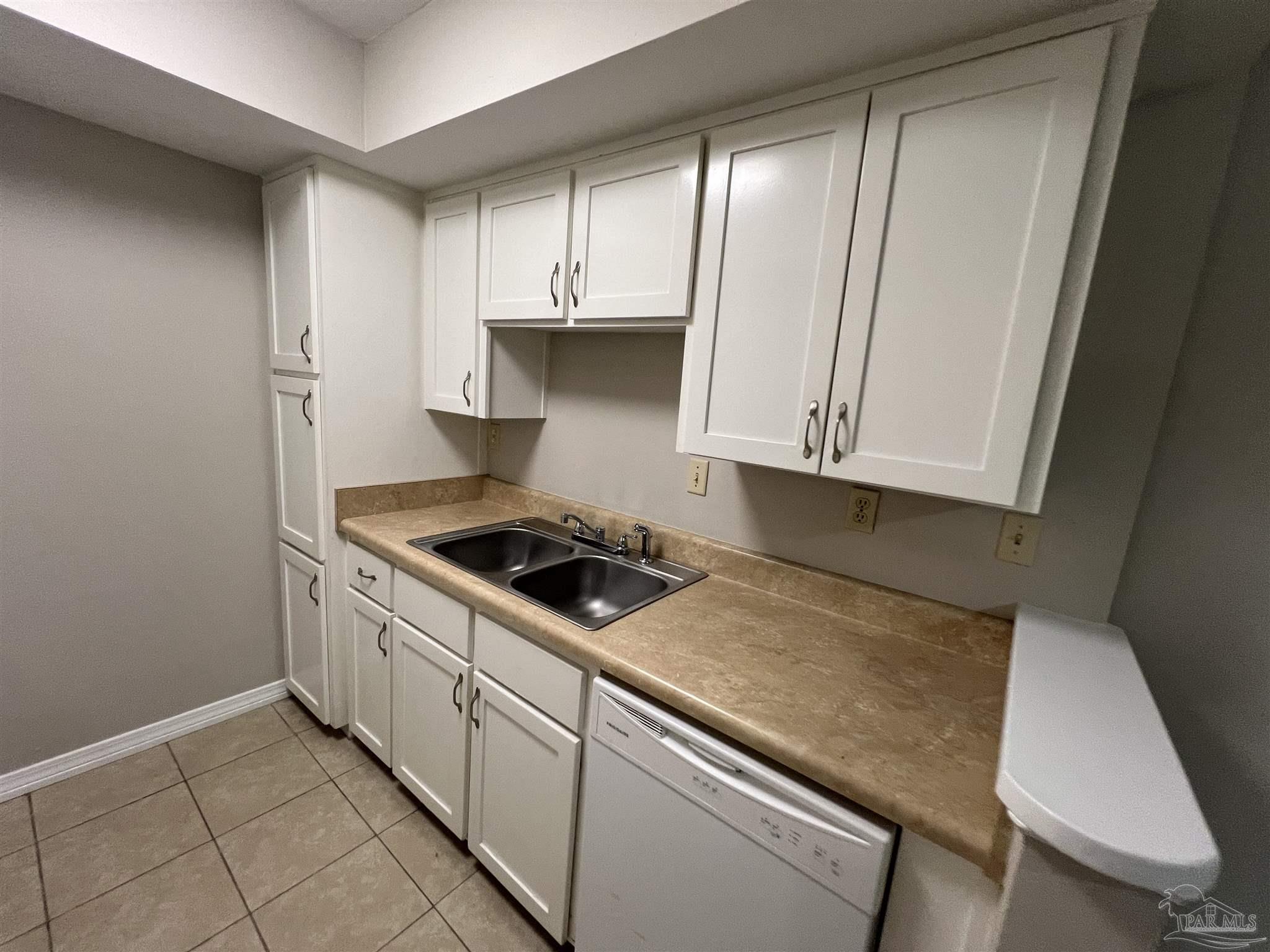 9485 Sunnehanna Boulevard Pensacola, FL 32514 - Photo 4 of 24 a kitchen with white cabinets and white appliances