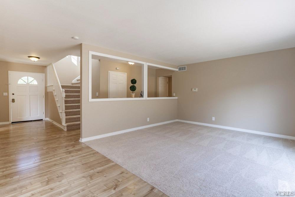 864 Appleton Road Simi Valley, CA 93065 - Photo 4 of 32 an empty room with wooden floor and windows