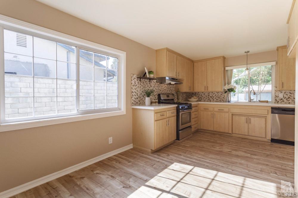 864 Appleton Road Simi Valley, CA 93065 - Photo 10 of 32 a kitchen with a sink window and cabinets