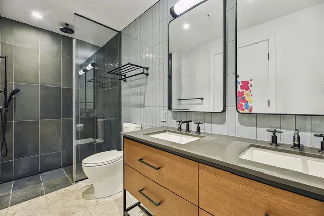 a bedroom with a bed and a large window with outer view