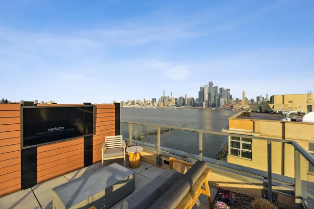 a view of a terrace with furniture and a kitchen