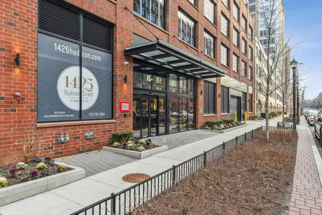 a view of a brick house with large windows