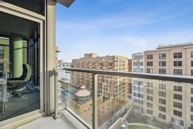 a spacious bedroom with a bed and large glass window