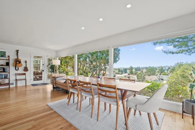 a view of a dining room with furniture window and wooden floor