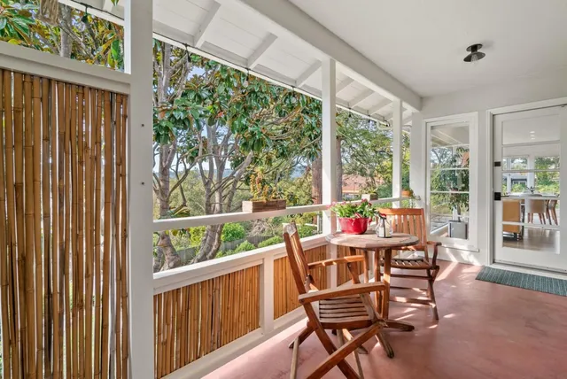 a view of a two chairs in the balcony