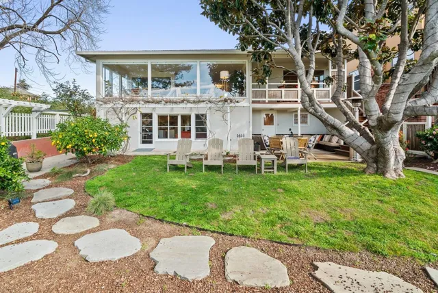 a view of a house with a backyard