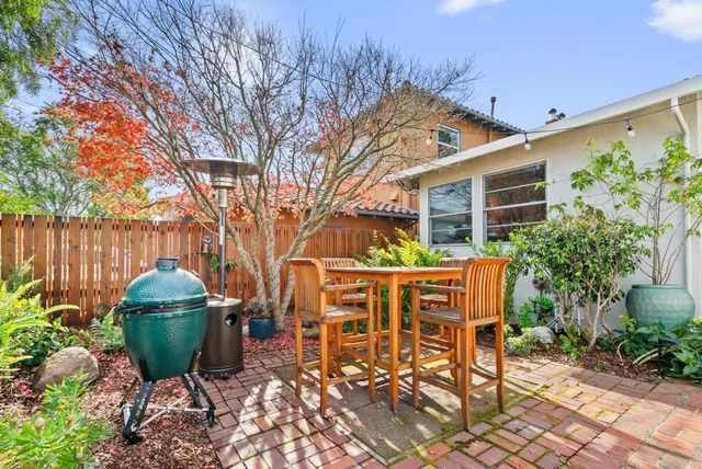 a backyard of a house with table and chairs