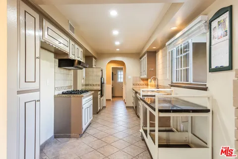 a kitchen with stainless steel appliances granite countertop a stove and a refrigerator