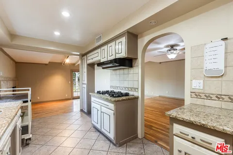 a kitchen with granite countertop a stove and a sink