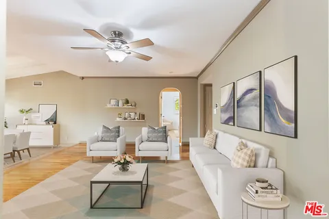 a living room with furniture and white walls