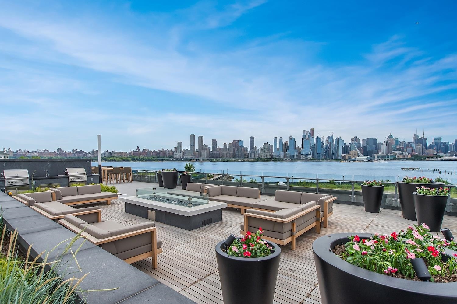 9 Ave At Port Imperial, Unit 925 West New York, NJ 07093 - Photo 10 of 14 a view of a roof deck with couches and potted plants