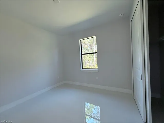 a kitchen with stainless steel appliances a refrigerator stove and white cabinets