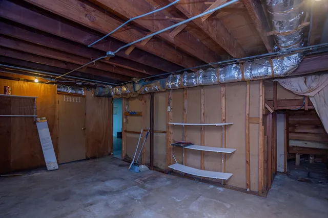 a view of an empty room with wooden shelves