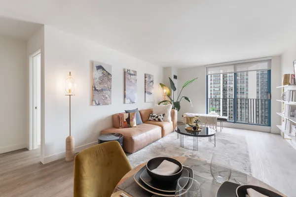 a living room with furniture and a floor to ceiling window