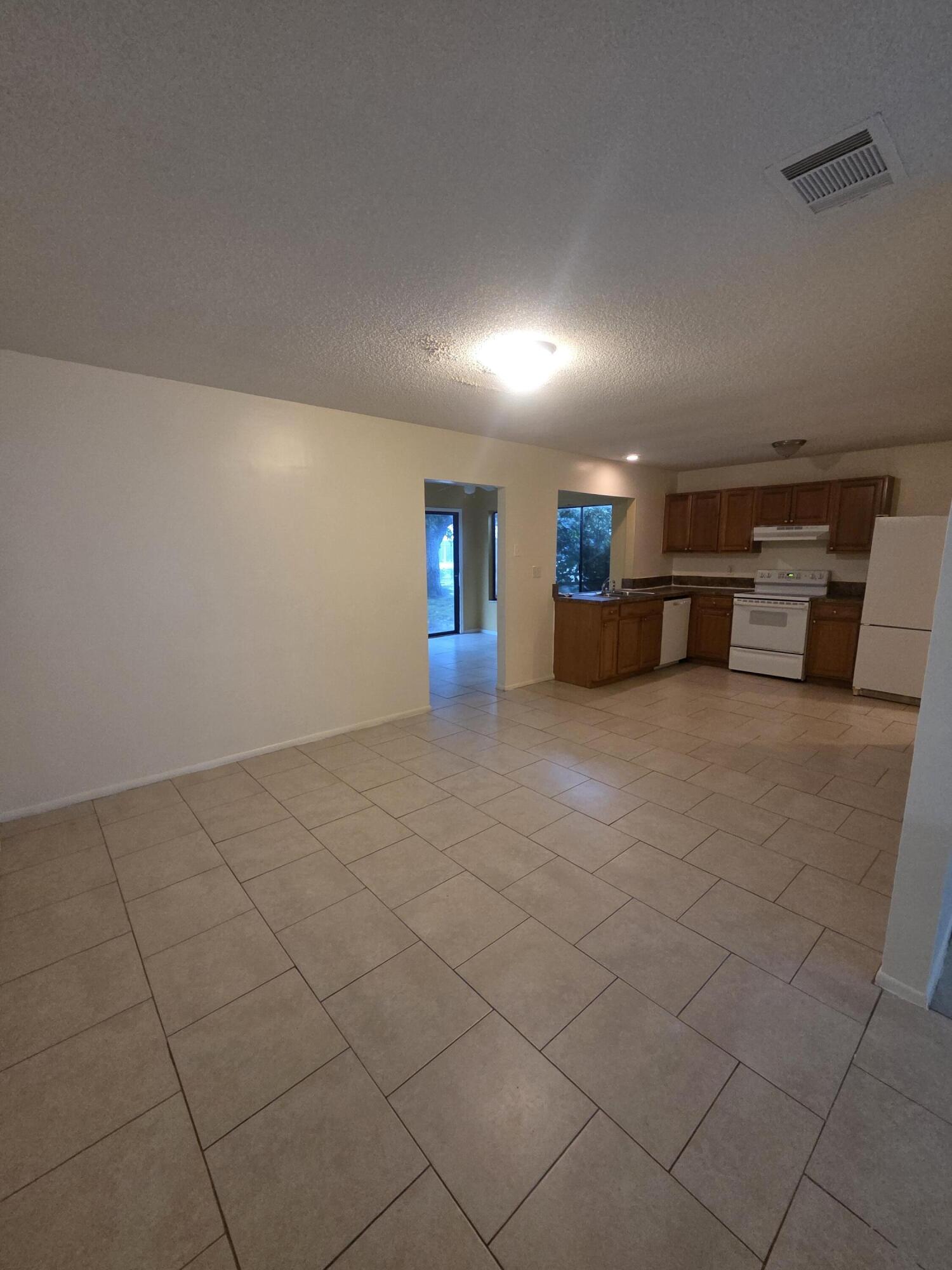 1917 Southeast Burgundy Lane Port St. Lucie, FL 34952 - Photo 4 of 13 an empty room with windows